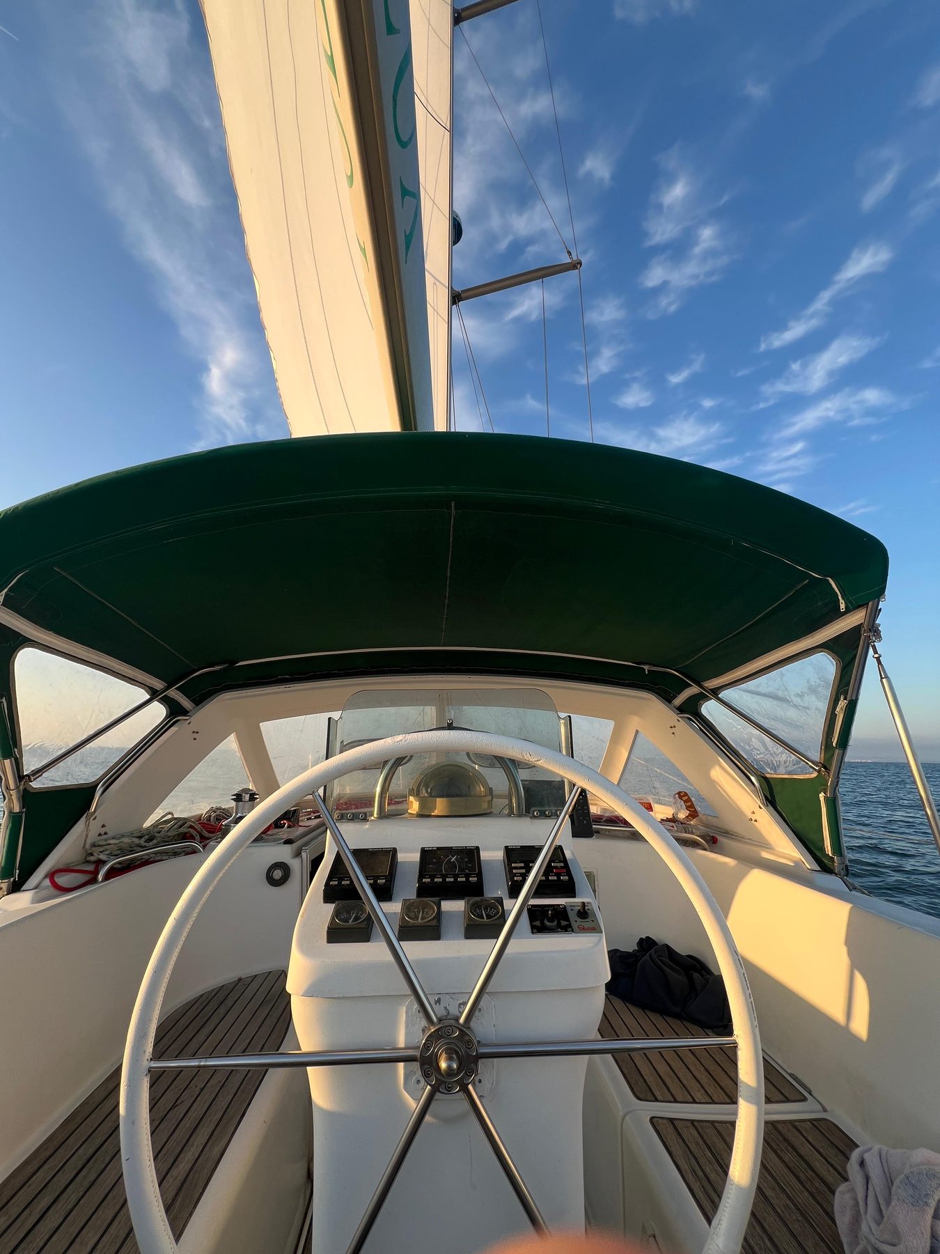 The Calma's center cockpit, wheel helm, green bimini
